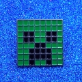 Przypinka metalowa Creeper Minecraft na niebieskim tle